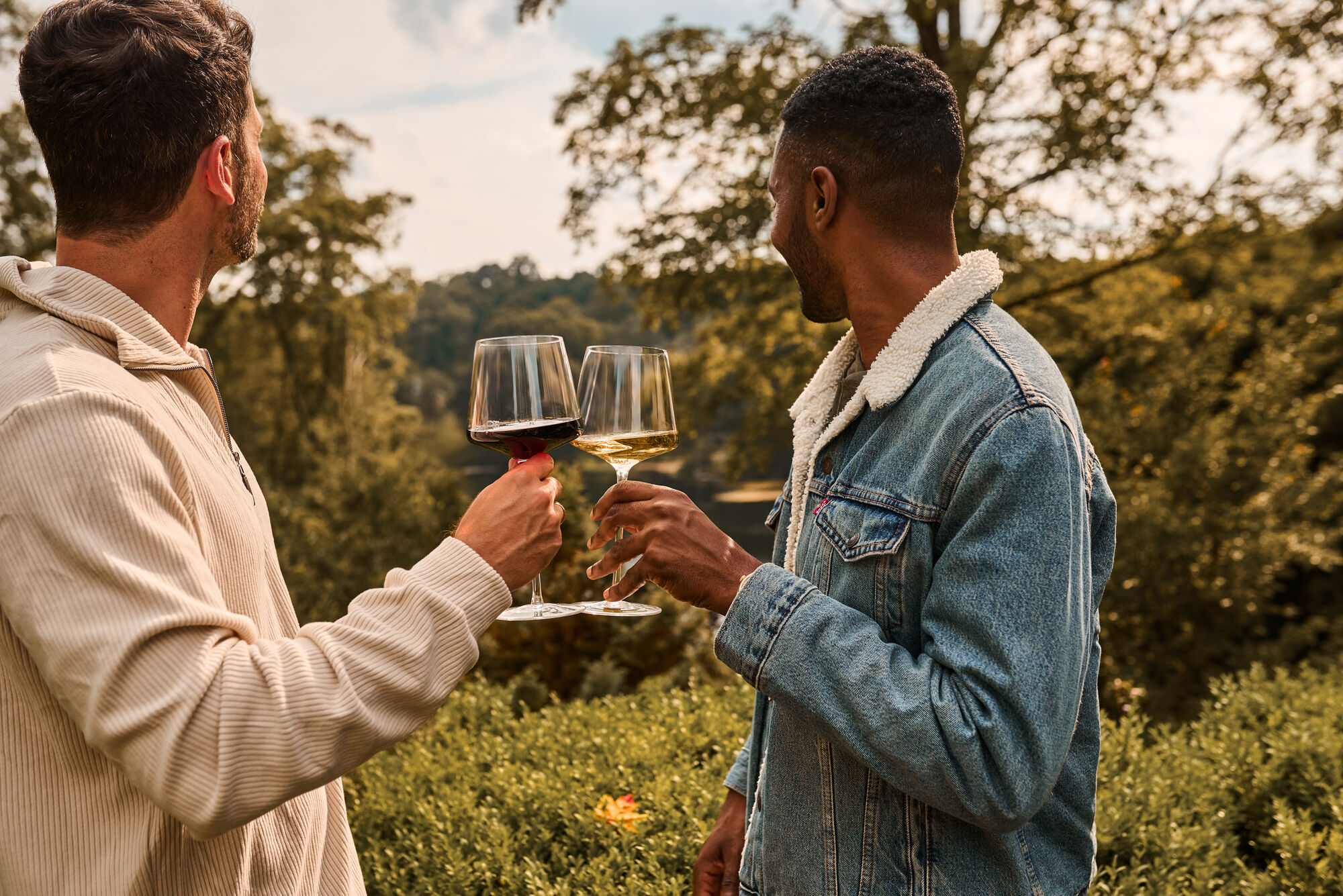 Two friends enjoying a glass of wine outdoors